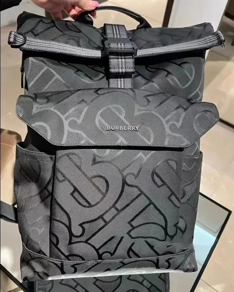 Brown leather tote bag shot on a phone in warm indoor light