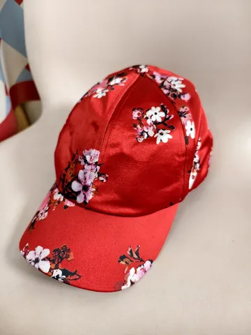 Floral baseball cap shot on a phone, on a display form