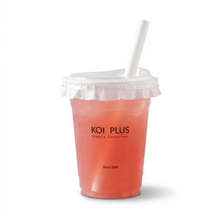 The same KOI PLUS cup on pure white after Foca AI — the pink drink and logo read clearly