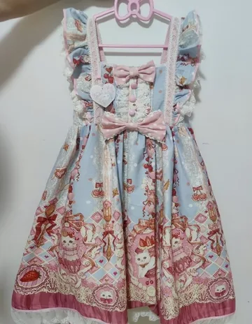 Floral Lolita JSK dress on a hanger, shot on a phone in warm indoor light