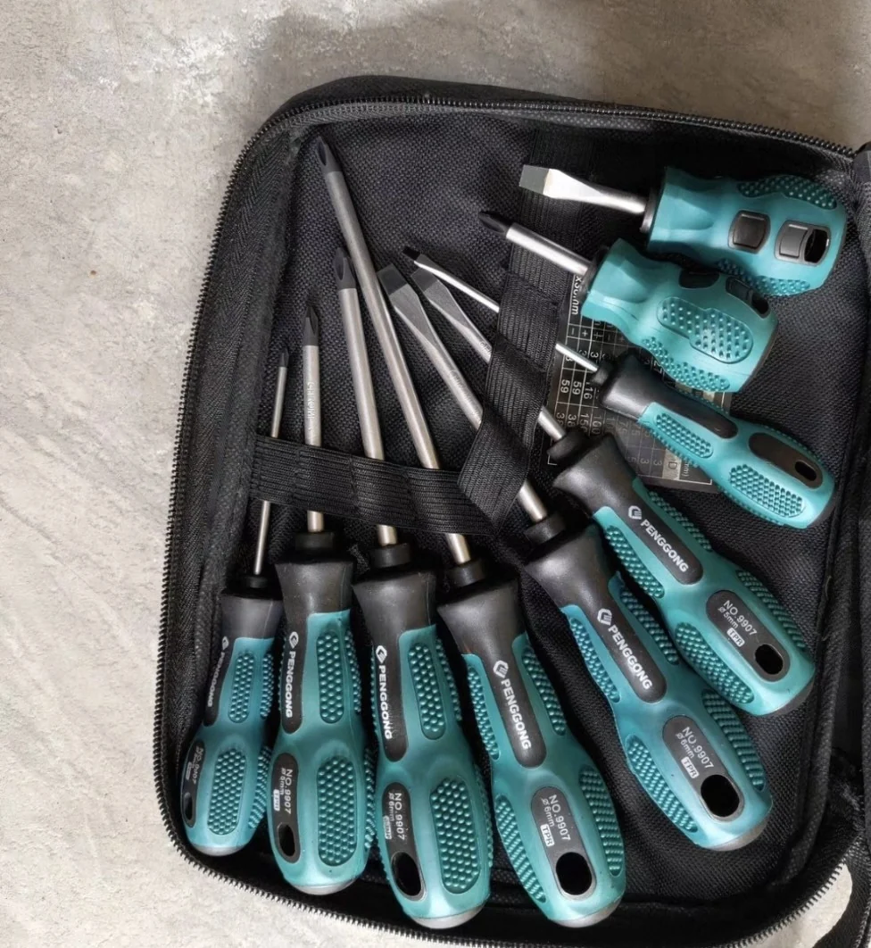 Screwdriver set shot on a phone inside a black tool pouch on a concrete floor