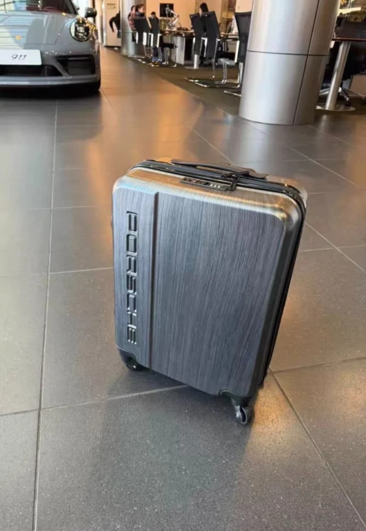 Hard-shell rolling suitcase shot on a phone on an airport floor with harsh overhead light